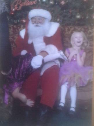 Vote for the best holiday photo Submitted by: Randi Slamiak of West Milford, N.J. "My daughter was terrified of Santa. She tried to get away. This is my favorite Christmas picture. I leave it out all year. Both santa and sister laughed so hard."