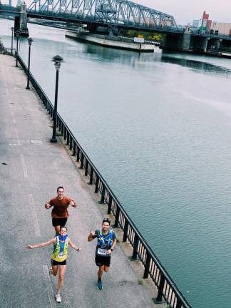 Aerial shot of Hanna Cavanagh running with two friends a long the Hudson River to spread voter awareness for the upcoming election.