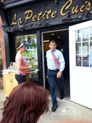 Slapping the hand that feeds Photo by Vicki Botta An state tax agent exits La Petite Cuisine last Wednesday as a member of the staff waits to enter the popular eatery.