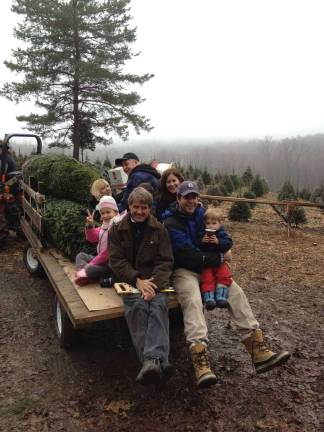 Photo provided by the Orange County Office of Tourism Visitors at Emmerich Tree Farm in Warwick have their freshly cut Christmas trees to bring home and decorate.