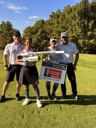 The Par 4 12th hole is always more fun when golfers can use the Air Cannon for their drive, reaching the green for an eagle putt. From left: Frank and Kim Corkum, and Amy and John Maggi.