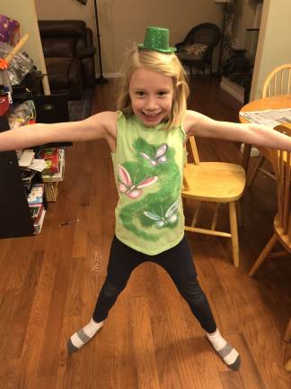 One Lucky Leprechaun The jumping jack leprechaun. Madison doing her exercises to prepare for her mischief. Photo courtesy of Karen.