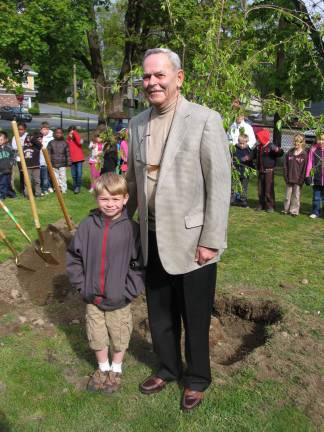 Warwick school children help plant a tree for Arbor Day Shade Tree Commissioner Roger Metzger, a 46-year veteran of the Commission, celebrated the event with his grandson Rory O'Connor.