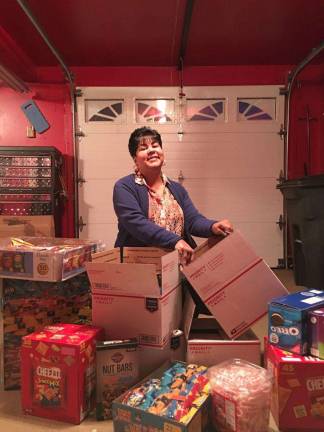 Support Our Heroes: They need to know they are not forgotten Lucy Mercado packing items for those serving overseas (Photo provided)