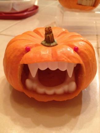 Carving it up Submitted by Alison Hainzl of Warwick, N.Y. She used novelty teeth to make these little vampire gourds.