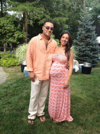 Love is in the air Josh and Kristin Young of Warwick, N.Y. "This photo was taken at my sisters wedding. I was 9 months pregnant. We got engaged the next day!"