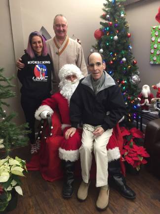 Santa visits local martial arts school Provided photo Pictured with Santa are Master Danielle Ciarfella, Grand Master Edmund Ciarfella and Glenn Dickes, director of the Warwick Ecumenical Food Pantry. A breakfast with Santa last Saturday at the United Martial Arts Centers in Warwick raised $1,000 for the food pantry.