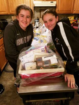 Lady Wildcat Softball players host fund raiser on May 1 Provided photos Jessie Tagg, a member of the junior varsity softball team, and Brigid Danaher, a member of the modified team, prepare the prizes that will be available during the Tricky Tray auction at the "Take me out to the Double D Smokehouse" fund raiser for the Lady Wildcat program on Tuesday, May 1.