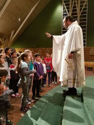 Spanish and English Mass at St. Stephen's honors Our Lady of Guadalupe Rev. Richard Marrano offered a special blessing for all the children.