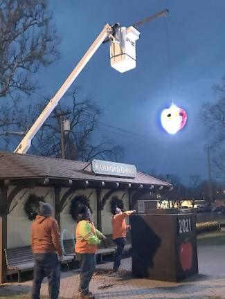 Raising the Apple. Photo provided by Mayor Michael Newhard.