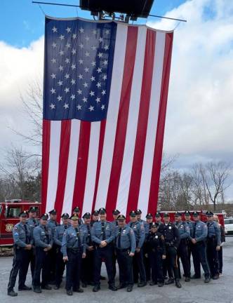 Flanked by Warwick Police Chief Thomas F. McGovern Jr. on his left and Lt. John Rader on his right, Officer Stephan Helmrich stands with his brothers and sisters in blue on the occasion of his retirement.