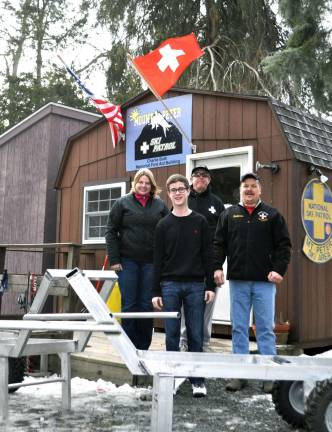 Troop 45 Eagle Scout candidate contributes two sled carts to Mount Peter Ski Patrol Pictured left to right; Rebecca Sampson Kulberg of Mount Peter Ski Center, Eagle Scout candidate Rober Hunter, Mike Meade, Mount Peter Ski Patrol, and Jim Mehling, Mount Peter Ski Patrol director.