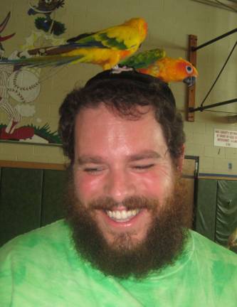 Dress up, step out for Purim Rabbi Pesach Burston, director of Chabad of Orange County, with parrot friends, gets into a Hawaiian groove.