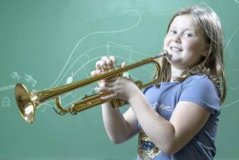 Sanfordville Elementary School fourth grader Addison Hurd poses for a portrait with her trumpet. She is a Superintendent's Artist of the Week. Tom Bushey