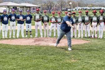 Wounded Warrior Project speaker Jake Norotsky throws out the first pitch surrounded by Warwick and North Rockland athletes on Rob Lattimer Baseball Field April 27, 2024.