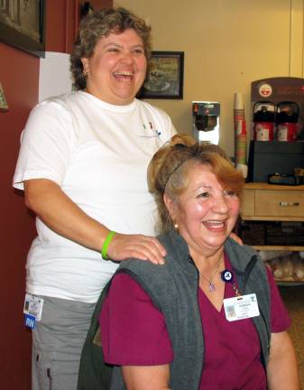 Hospital employees learn small changes can make a big difference Mount Alverno Garden CafÈ Hostess Zorie Cruz, seated, and St. Anthony Community Hospital Emergency Room Manager Joie Ogrodnick enjoy a light moment during a demonstration by Ogrodnick of the Isabell Gatto Method of Therapeutic Accupressure.