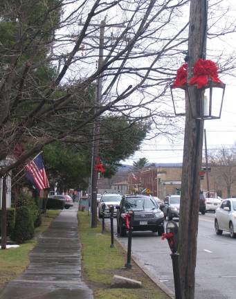 Custom-made lanterns add charm to the village Custom-made lanterns decorate Village of Warwick during holiday season WARWICK ñ This year, for the first time, holiday decorations along Main Street have included new lanterns, designed and manufactured by John Redman, to enhance the Villageís Historic District.