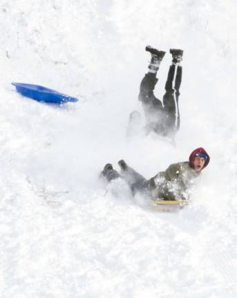 (S)no problem Photo by Robert G. Breese Thomas Wightman wipes out on Raynor hill while his friend John Kunzweiller holds on for the ride.