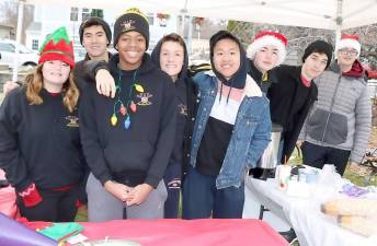 On Sunday, Dec. 15, members of the Warwick Valley High School Crew Team were stationed on Railroad Green and selling donuts, cider and hot chocolate to help support their sport.