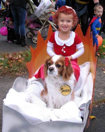 Halloween makes a comeback "Little Orphan Annie," Violet Tinnirello, 4, with her dog Lola as "Sandy."