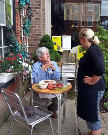 Slapping the hand that feeds Photo by Vicki Botta Jen Haesche, owner of Le Petite Cuisine, explains to a patron why state tax agents were swarming her business, changing the locks and shutting her down.