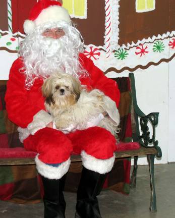 Buster, Shirley Figueroa's Shih Tzu, hammed it up with Santa.
