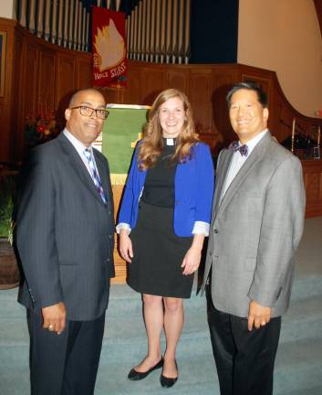 The Rev. Stacey Duensing, center is greeted by Pastor Rolfi Elvio-Lopez, left, of Hispanic Ministries, and George Jung, vice president, at her first service on Sunday morning, Sept. 8, at the Warwick Reformed Church.