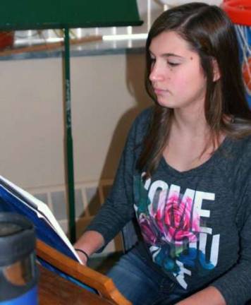 Sharing Christmas joy at Mt. Alverno Eighth grader Madeline Rudy played holiday songs on the piano during the Warwick Valley Gardeners Garden Therapy team's recent flower arranging activity at Mount Alverno.