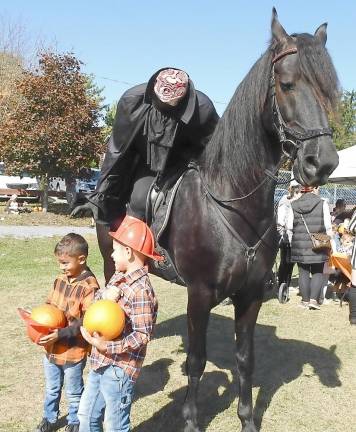 The Headless Horseman (actually Leora Dillion) galloped through the park to the delight of all.
