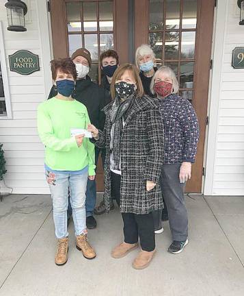 Christine Stage presents a donation from the Warwick Town Democratic Committee to the good folks who run the food pantry in the Village of Florida.