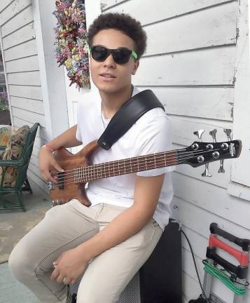 Warwick Valley High School junior Timothy Leonard at home with his bass.