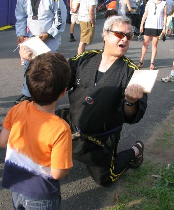Warwick Firefighters host annual summer carnival Photos by Roger Gavan After a brief lesson George Grasso, 5, used his bare hand to split a board held by Master Gary Paolini of Warwick's United Martial Arts Center.