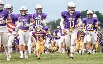 The Warwick Valley Wildcats take the field with the Warwick Youth Football Mighty Mites on Youth Football Night last Friday, Sept. 17. The Wildcats defeated Washingtonville 28–14. Photo by Al Konikowski.