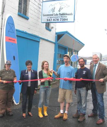 Greenwood Lake Paddleboards moves across the water On Thursday, June 12, members of the Warwick Valley Chamber of Commerce and the manager of the SportmanþÄôs Marina joined owners Chaz Corallo and Theresa Sparkes for the grand reopening of Greenwood Lake Paddleboards at its new location. From left, Warwick Valley Chamber of Commerce member Danielle Barbour, Chamber President Sherry Bukovcan, owners Theresa Sparkes and Chaz Corallo, SportmanþÄôs Marina Manager Drew Anoll and Chamber Executive Director Michael Johndrow.