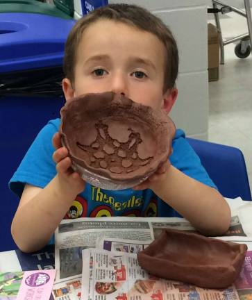 WVHS's Empty Bowls '18 raises more than $3,300 to fight local hunger A young potter proudly displays his clay bowl.