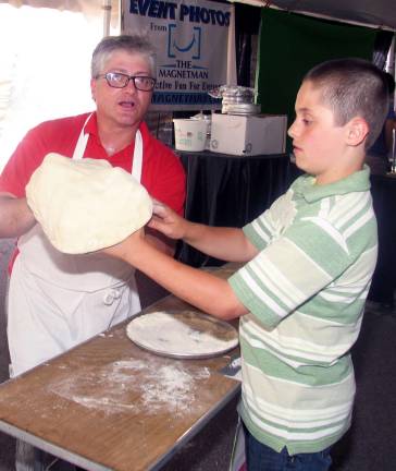 Taste of the Town raises $17,000 for St. Stephens parish and school Matt Rinaldi from Frank's Pizza prepares Luke Rich, 11, for the "Pizza Toss" event.