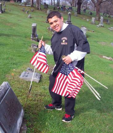 1,600 flags Photos by Roger Gavan Dylan Claudio was among the Boy Scouts from Troop 45 and volunteers from WarwickþÄôs American Legion Post 214 and VFW Post 4662 to placing more than 1,600 flags at the local grave sites of veterans throughout the area. (Additional photos can be found online at warwickadvertser.com.)
