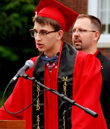 Cheers to the George F. Baker High School Class of 2015 Paul Jones leads his classmates in the Pledge of Allegiance.
