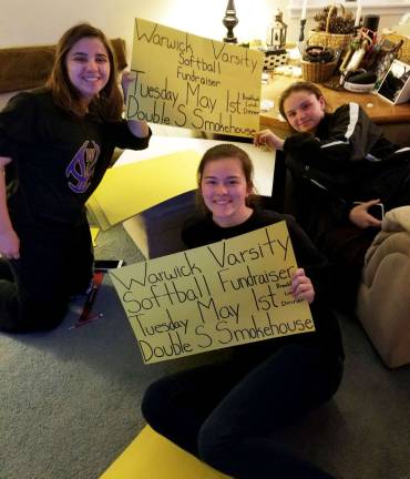 Lady Wildcat Softball players host fund raiser on May 1 Jessie Tagg, junior varsity, Brittany Tagg, varsity, and Katelyn Pinskey, varsity, prepare signs for the May 1 fund raiser for the Lady Wildcat program at the Double D Smokehouse in the Village of Warwick.