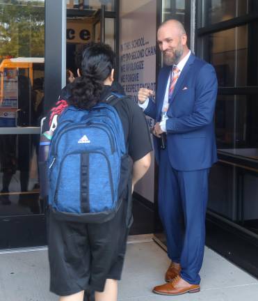 School principals honored during Appreciation Month S.S. Seward principal Michael Maesano gives a student a fist bump.