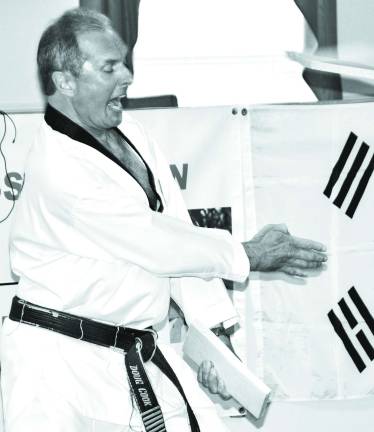 Academy hosts martial arts seminar Master Doug Cook of the Chosun Taekwondo Academy demonstrates his speed wood-breaking technique.