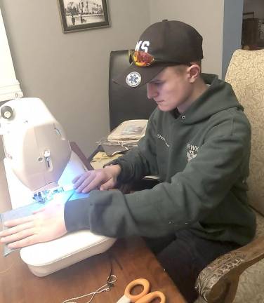 Shea Patterson, 16, a sophomore at John S. Burke Catholic High School and an EMT volunteer, learned a new skill making masks for Warwick’s Emergency Medical Services.