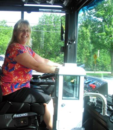 Town of Warwick acquires hybrid vehicle for Dial-A-Bus service Photo by Roger Gavan Supervisor of Transportation Jennifer Crover at the wheel of the new hybrid diesel-electric bus.