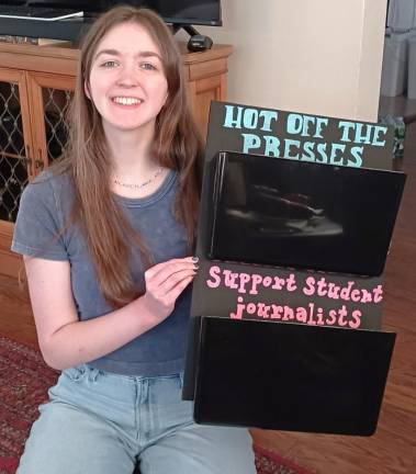 Seniors leave their mark with projects Malina Grove with an organizer she designed, built, and installed to hold and advertise the school newspaper.