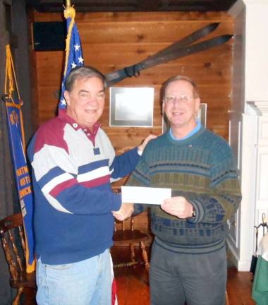 Locals donate for purchase of second Rotary Shelter Box Photo By Roger Gibboni Stan Martin, left, a local Rotarian and member of the District Governor's management team, receives a check from Warwick Valley Rotary Club President Neil Sinclair to purchase a second Shelter Box to aid typhoon victims in The Philippines.