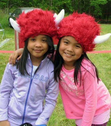 Thousands participate in Warrior Dash at Warwick Day Camp Photo by Roger Gavan Friends Samentha,8 and Xybil,9, enjoy wearing their new fuzzy Warrior helmets.