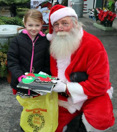 Christmas events celebrated at Pennings Farm Market Photos by Roger Gavan There were visits and photo opportunities with Santa and in one case Emma O'Leary, 5, turned the tables on Santa by presenting him with gifts including a painting.