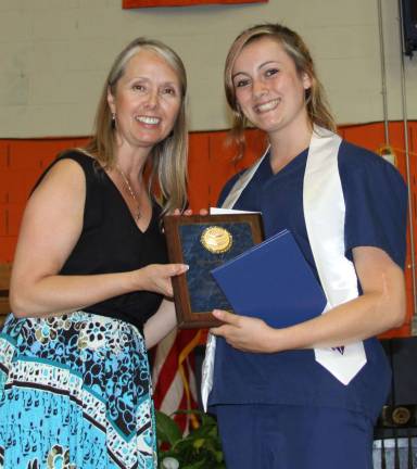 BOCES award and scholarship winners Sierra Cassano, a graduate from Warwick Valley High School and a student in the Orange-Ulster BOCES Career & Technical Education CenterþÄôs Health Careers Academy, was the recipient of the Outstanding Health Careers Academy Award. She is pictured receiving her award from Cooperative Board Member Virginia Esposito.