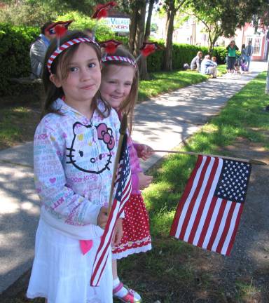 Warwick honors its veterans Photo by Roger Gavan Kaitlin Kostic, 7, and her sister Emma, 5, patiently await the start of the parade. Additional photos can be found online at warwickadvertiser.com.
