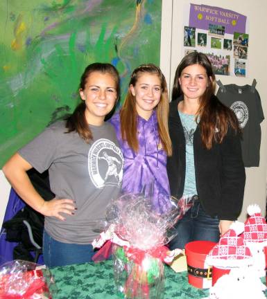 Twenty-seven years in the making Members of the Warwick Varsity Softball Team raise money for the Make a Wish Foundation at the 27th annual December craft fair. From left sisters Kayla and Alyssa Corkum and team mate Ciarra Diguilio.